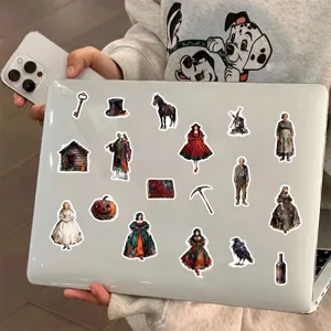 Detail view of retro oil painting style stickers with Gothic characters on a white laptop
