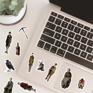 Vintage oil painting character stickers applied to a modern laptop lid.