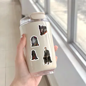 Detail view of vintage Sleepy Hollow oil painting stickers on a white travel mug