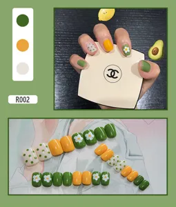 Full set of 24 cute green and yellow press-on nails with daisy flower and dot patterns