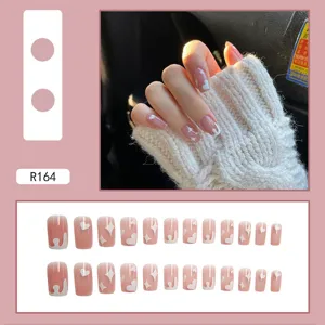Pink French press-on nails with white heart and star designs for daily wear