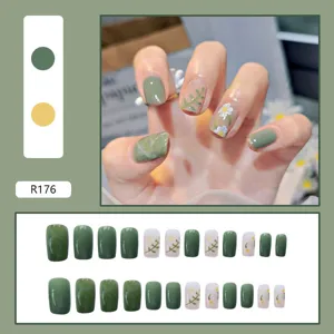 Close-up detail of green marble and daisy pattern press-on nails set with 24 pieces