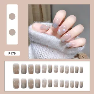 Detail view of nude press-on nails with silver glitter and star cloud patterns