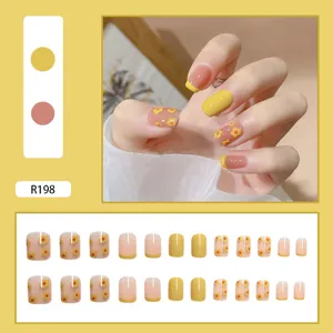 Detail view of yellow French tip press-on nails with daisy floral patterns, 24pcs set.
