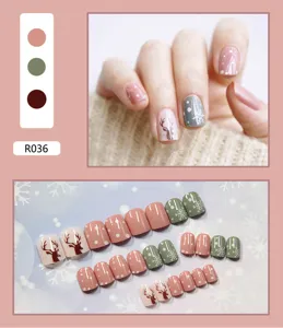 Close-up detail of Christmas themed press-on nails with reindeer and snowflake patterns
