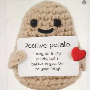 Handmade crochet positive potato plush toy close-up detail showing cute face and card.