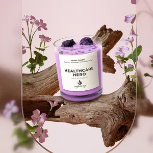 Purple scented candle in glass jar with crystal stones and grapefruit fragrance for home gift.
