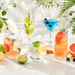 Detail view of transparent glass straws in various drinks, featuring straight and bent styles.