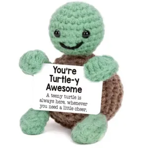 Handmade crochet turtle plush toy holding a positive quote card, cute desktop decompression doll.