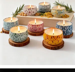 A collection of aromatic candles in patterned tin jars lit on rustic wooden coasters