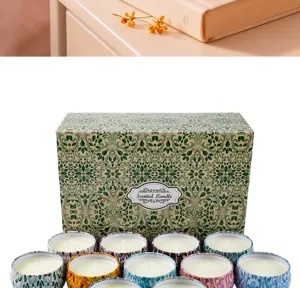 Detail view of a 12-piece scented candle gift set featuring various patterned tins