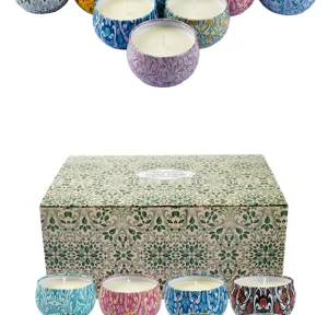 Macro view of patterned tins and gift box from a 12-piece scented candle collection
