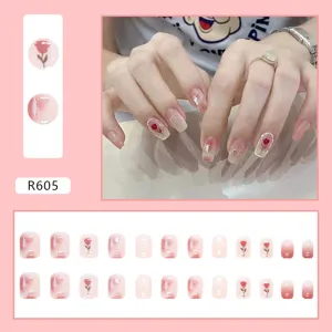 Pink aurora press-on nails with elegant rose patterns, 24 piece set detail and hand view.
