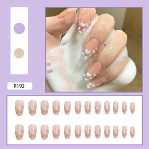 Close-up detail of purple and nude heart pattern press-on nails set with model R192.