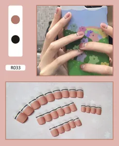 Detail view of 24pcs pink and white matte press-on nails with black line design