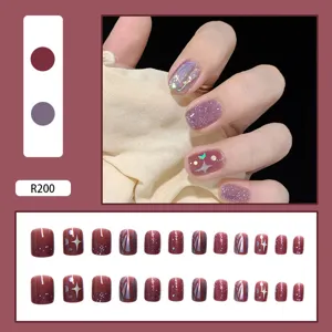 Full set of glitter press-on nails in burgundy and purple with star moon patterns