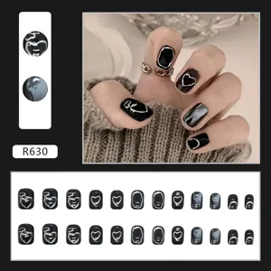 Detailed view of 24pcs black press-on nails with silver 3D heart and abstract art designs