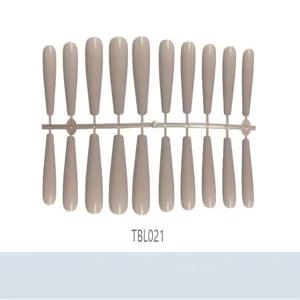 Macro detail view of professional nude coffin false nails on a sprue rack with glossy finish
