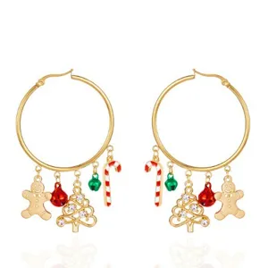 Close-up detail of festive Christmas hoop earrings with gingerbread and tree charms