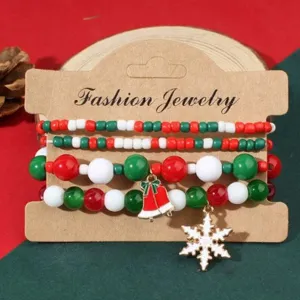 Macro detail of Christmas beaded bracelet set featuring festive snowflake and bell charms