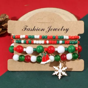 Close-up of Christmas beaded bracelet set featuring festive red green beads and charms