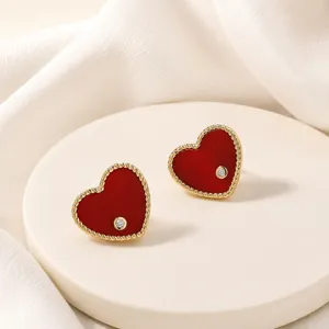 Elegant heart stud earrings with red enamel and zircon detail in 18K gold plating finish