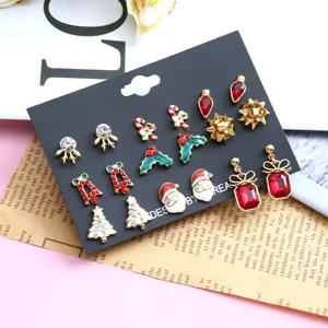 Detailed view of festive Christmas earring set with Santa and tree motifs