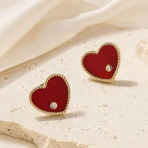 Close-up view of red enamel heart stud earrings with 18K gold plated twisted rope border