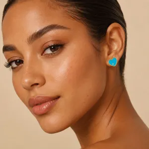 Close-up detail of 18K gold plated blue enamel heart stud earring with zircon on model
