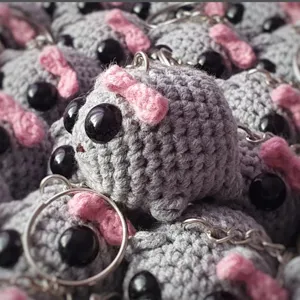Handmade crochet sad hamster keychain with pink bow, cute plush backpack charm pendant.