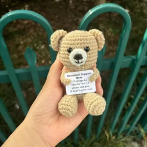 Handheld crochet emotional support bear toy detail shot showing cute handmade stitches.