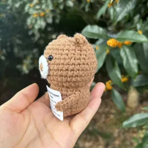 Handmade crochet emotional support bear with card, detailed view of cute plush toy.