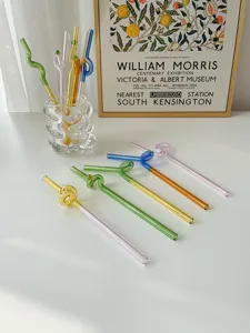 Colorful glass twisted straw detail shot, cute heat-resistant coffee stir bar aesthetic setup.