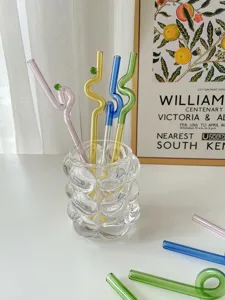 Colorful glass drinking straws with cute twisted design, reusable heat-resistant coffee stirrers.