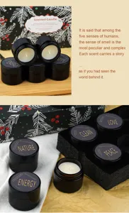 Gift scented candle set detail, black glass jar with soy wax, aromatic fragrance display.
