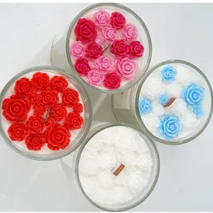 Handmade scented soy candles with decorative rose wax flowers in glass jars set of four.