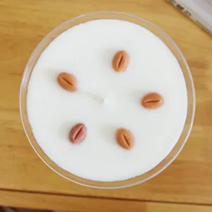 Martini glass scented candle detail, white wax with coffee bean decorations for cozy home decor