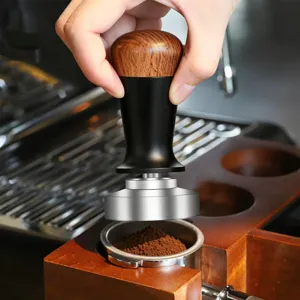 Wooden coffee tamper with stainless steel base for espresso machine portafilter tool.
