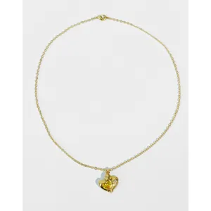 Detailed view of gold heart pendant necklace featuring sparkling yellow zircon inlay