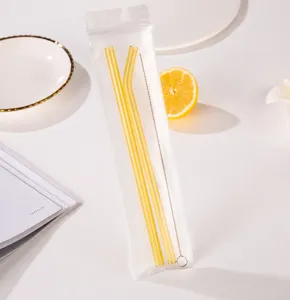 Clear glass straw set with cleaning brush, transparent packaging display detail view.