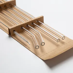 Clear glass straw set with cleaning brush and eco kraft paper packaging for daily eco use.