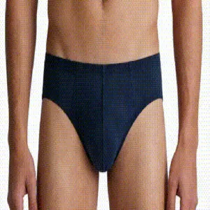 Detailed view of men's navy blue breathable seamless cotton briefs on a model