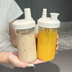 Close-up of portable heat-resistant straw cups for bubble tea and juice with white lids.