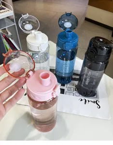 Detailed view of portable plastic sports water bottle with scale and pop-up direct drinking lid.