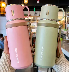 Close-up of pink and green 316 stainless steel vacuum flasks with portable straps