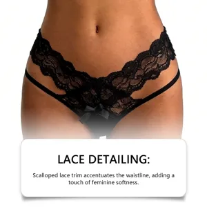 Close-up detail of black lace thong, scalloped lace trim and bow accent for intimate wear.