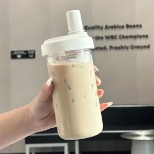 Minimalist large capacity plastic straw cup with iced milk tea held in hand