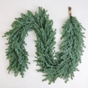 Detail view of a soft-touch artificial Norfolk pine garland for Christmas decoration.