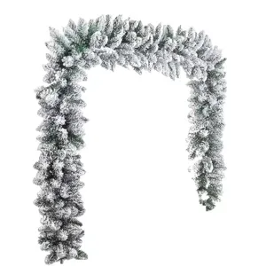 Detailed view of artificial flocked Christmas garland with dense white snow effect