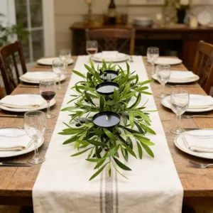 Detailed close-up of an iron olive branch candle holder on a festive dining table